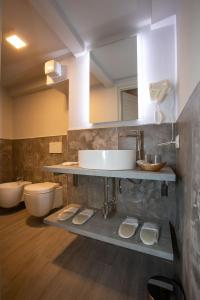 a bathroom with a sink and a toilet at AL 54 Accommodation - Premium in San Benedetto del Tronto