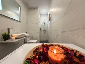 a candle sitting on a table in a bathroom at Alexandros Luxury Apartment in Glossa
