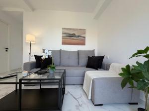 a living room with a couch and a table at Alexandros Luxury Apartment in Glossa