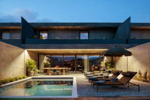 a house with a swimming pool and a patio at Residence - Signature Villas in Lagoa
