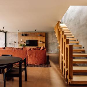a staircase in a living room with a couch and a table at Residence - Signature Villas in Lagoa
