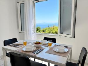 a dining room with a table and a window at Alexandros Luxury Apartment in Glossa