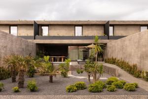a house with a courtyard with trees and plants at Residence - Signature Villas in Lagoa