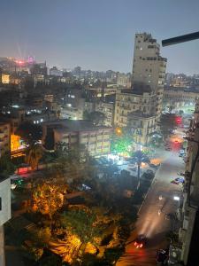 a city at night with buildings and street lights at Nada HOTEL in Cairo