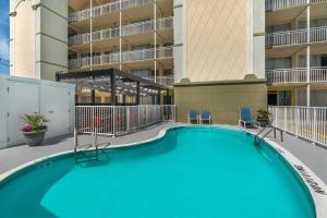 a swimming pool in front of a building at SureStay Hotel by Best Western Virginia Beach Royal Clipper in Virginia Beach