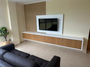a living room with a couch and a flat screen tv at Pilgrims House II in Lourenzá