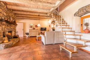a living room with a staircase and a fireplace at Rustic Villa Lavanda - Pool & Garden - Happy Rentals in Šmarje