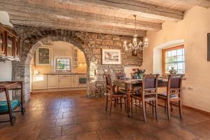 a dining room with a table and a stone wall at Rustic Villa Lavanda - Pool & Garden - Happy Rentals in Šmarje +24 photos
