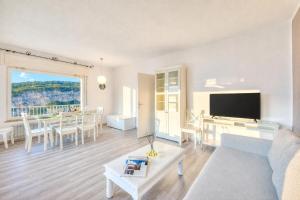 a living room with a couch and a table at Villa Panorama with Private Pool in Nago-Torbole
