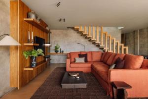 a living room with a couch and a staircase at Residence - Signature Villas in Lagoa