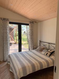a bedroom with a bed and a sliding glass door at WieloHome in Wielogóra