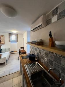 a kitchen with a sink and a living room at Studios Jacobus in Korčula +49 photos