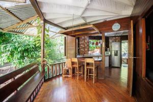 a room with a table and chairs on a balcony at Bungalows Aché Cahuita in Cahuita