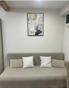 a couch with two pillows against a white wall at Apartman Blue Moon Split- free parking in Split