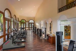 a gym with a row of treadmills and ellipticals at Casa Velas Adults Only All Inclusive in Puerto Vallarta