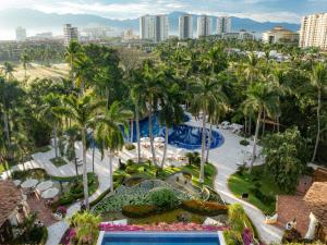 an aerial view of a resort with a pool and palm trees at Casa Velas Adults Only All Inclusive in Puerto Vallarta