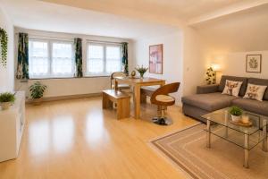 a living room with a couch and a table at Ferienwohnung Attersee in Steinbach am Attersee