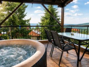 a hot tub on a patio with a table and chairs at Villas Lirtzis in Taxiarchis