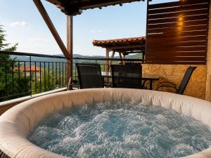a hot tub on the deck of a house at Villas Lirtzis in Taxiarchis +69 photos