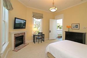 a bedroom with a bed and a fireplace at The Gables Inn Sausalito in Sausalito