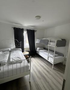 a bedroom with two bunk beds and a window at Gästehaus OG in Cologne