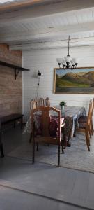 a dining room with a table and two chairs at Romantic farmhouse in Vaksdal