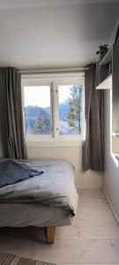 a bedroom with a bed and a large window at Romantic farmhouse in Vaksdal
