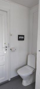 a bathroom with a toilet and a picture on the wall at Romantic farmhouse in Vaksdal +13 photos