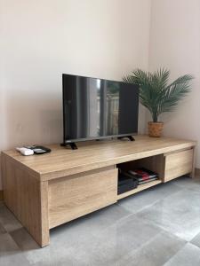 a wooden entertainment center with a flat screen tv on it at SWP Plac Solny 4 z klimatyzacją in Głogów