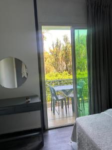 a bedroom with a table and chairs on a balcony at Chambre du jardin in Rabat