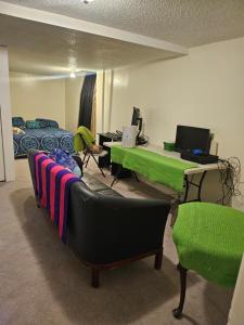a room with a bed and a desk with a laptop at Plantlife LLC Lodge D in Minneapolis
