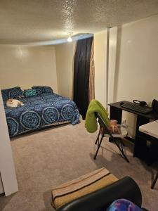 a room with a bed and a desk and a computer at Plantlife LLC Lodge D in Minneapolis