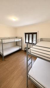 a room with three bunk beds in it at Albani Hostel in Palmela