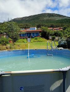 a pool of water with a slide in front of a house at Casa Carballar in Oia