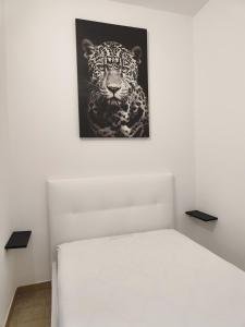 a bedroom with a black and white tiger picture on the wall at luxury studio in Gallipoli