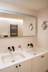 a bathroom with two sinks and a mirror at Vertry at Sea, Luxury Apartment Knokke in Knokke-Heist +14 photos