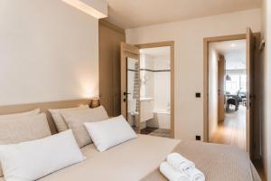 a bedroom with a white bed with white pillows at Vertry at Sea, Luxury Apartment Knokke in Knokke-Heist