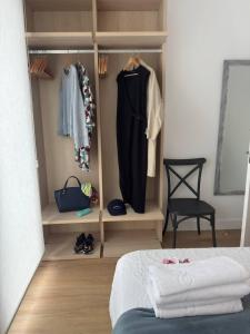 a bedroom with a closet with clothes and a bed at Alojamientos Dima Costa in Laredo