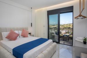 a bedroom with a bed and a large window at Blue Sunrise Villa 2 in Afantou +181 photos