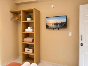a room with a tv on the wall at Palma 11 Boutique House Downtown Cancun in Cancún