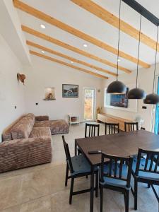 a living room with a table and a couch at Casa Bellea in Belej