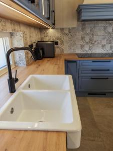 a kitchen with a white sink and a counter at Casa Bellea in Belej +34 photos