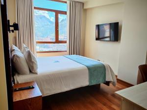 a bedroom with a bed with a large window at Muña Hotel Andahuaylas in Andahuaylas +62 photos