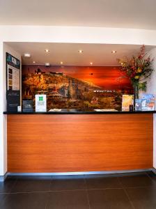 a restaurant with a large painting on the wall at ibis Styles Broken Hill in Broken Hill +51 photos