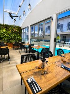 a restaurant with tables and chairs and a pool at ibis Styles Broken Hill in Broken Hill