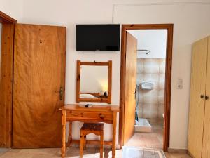 a bathroom with a wooden table and a mirror at Villa Xenia in Ammoudia +68 photos