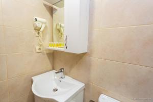 a bathroom with a sink and a phone on the wall at Hotel Scorpio gonio in Gonio +17 photos