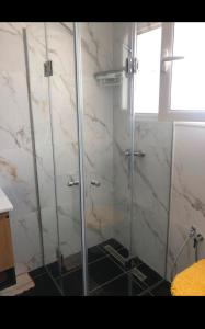 a shower with a glass door in a bathroom at Studio Hergla in Sidi Bou Ali +7 photos