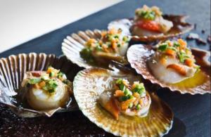 a group of oysters with ingrediants on a plate at Casa de la bis in A Guarda