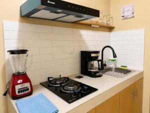 a kitchen counter with a blender on a stove at Palma 11 Boutique House Downtown Cancun in Cancún